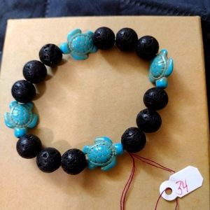 Artemis's Gems custom-made beaded bracelet with turquoise sea turtles/lava rock
